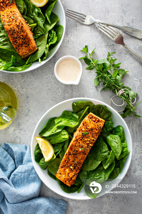 Cedar plank grilled salmon with spinach and spicy cream sauce