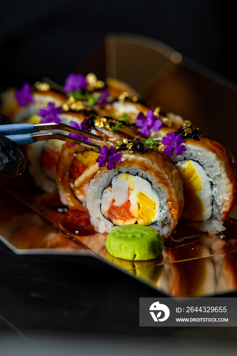 chef decorating sushi rolls