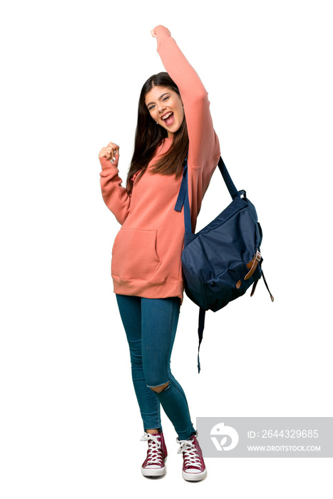 A full-length shot of a Teenager girl with sweatshirt and backpack celebrating a victory