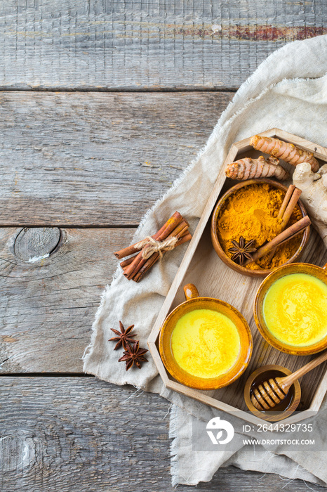 Traditional indian drink turmeric curcuma golden milk with ingredients