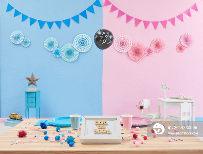 Gender party, close up table, blue and pink wall and question mark ballon.