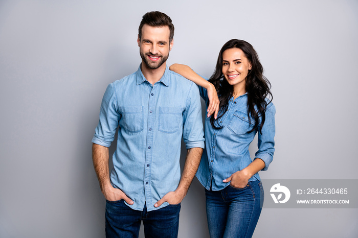 Portrait of charming millennial students workers freelancers entrepreneurs take decisions solutions achieve aims touching shoulders by arms dressed in blue denim outfit on ashy-gray isolated