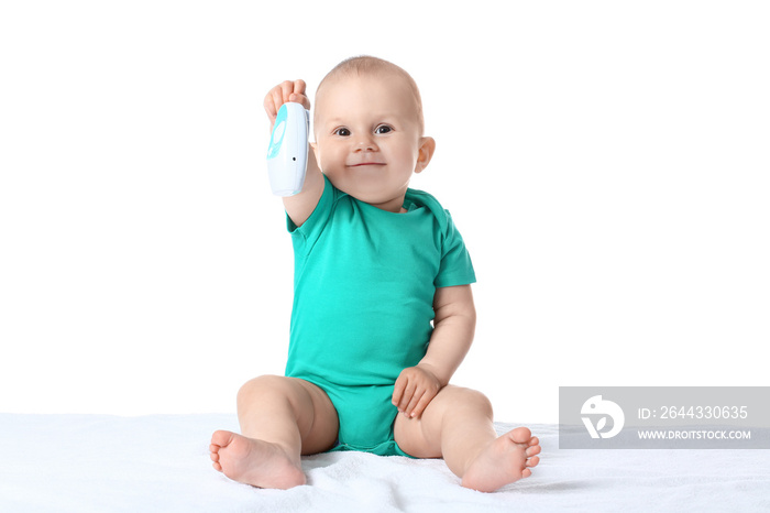 Cute little child with baby monitor on white background