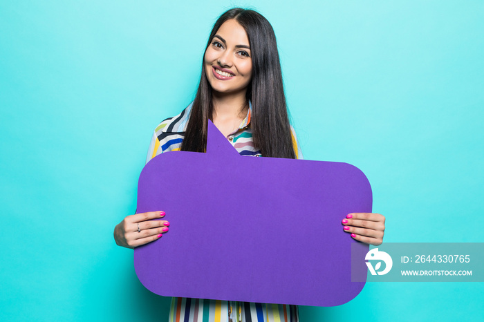 Young woman holding a speech bubble on a blue background