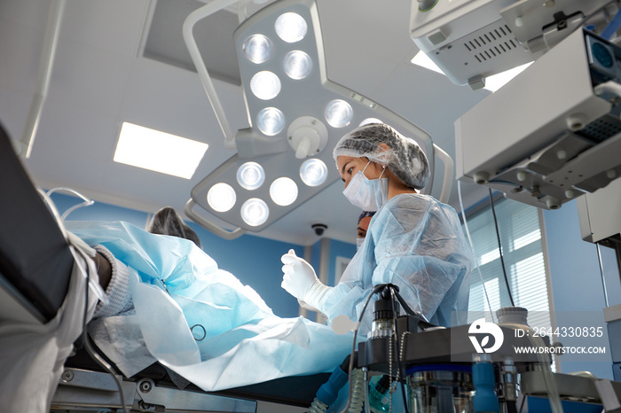 Concentrated Surgical team operating a patient in an operation theater