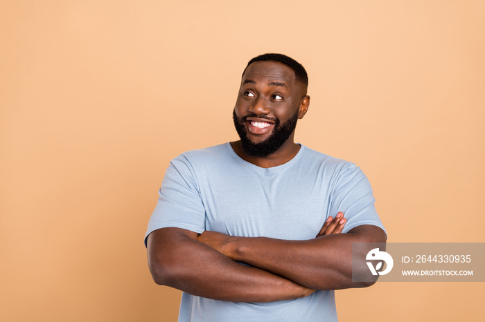 Photo of cool millennial brunet guy crossed arms look up wear blue outfit isolated on beige color background