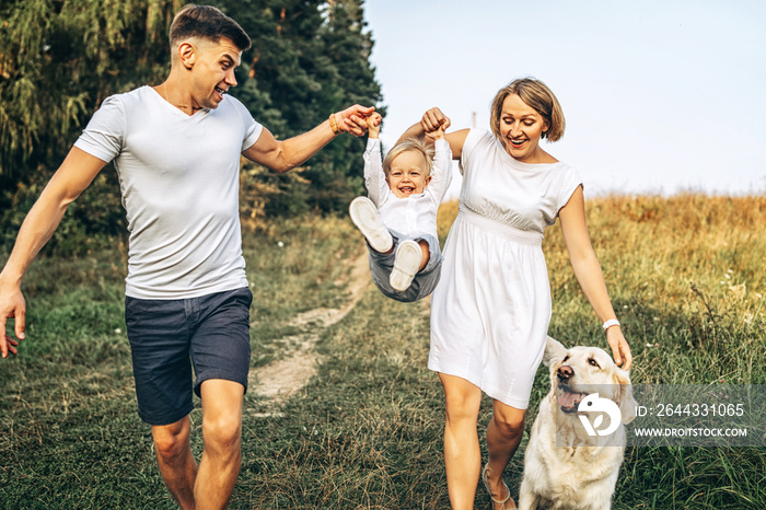 Young happy family with dog have fun outdoor