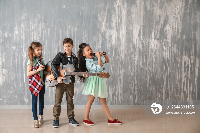 Band of little musicians against grunge wall