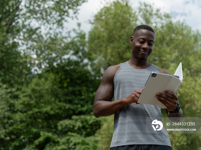 Smiling man using digital tablet outdoors