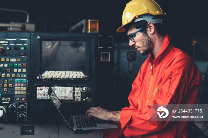 Skillful factory worker working with laptop computer to do procedure checklist . Factory production line operator occupation quality control concept .