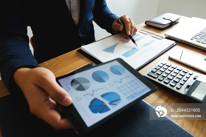 Businessman using tablet to the situation on the market value , Business concept.