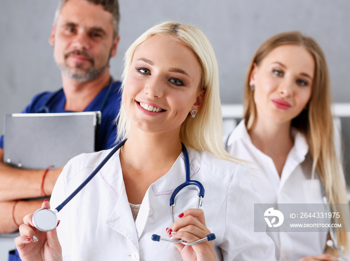 Group of medics proudly posing in row and looking in camera smiling. High level service, best treatment, 911, professional, healthy lifestyle, therapeutist consultation, physical, emergency concept