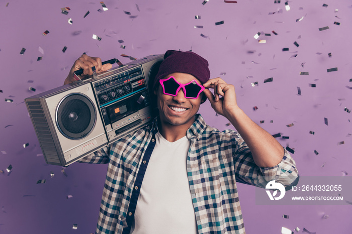 Close up portrait of carefree handsome with toothy beaming smile student millenial enjoying best event ever holding cassette radio player wearing street style clothes isolated violet background