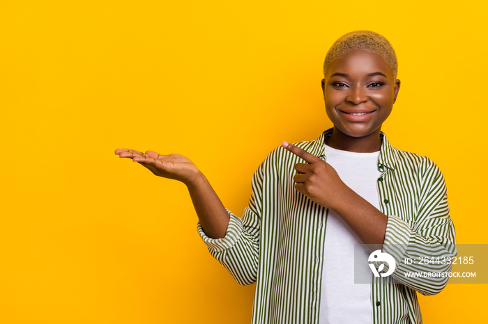 Photo of positive person direct finger hand palm demonstrate empty space proposition isolated on yellow color background