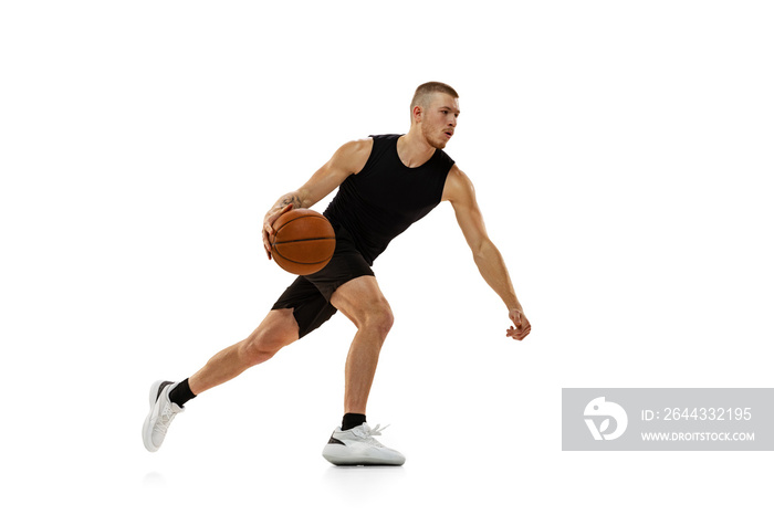 Young muscled man, basketball player practicing with ball isolated on white studio background. Sport, motion, activity concepts.