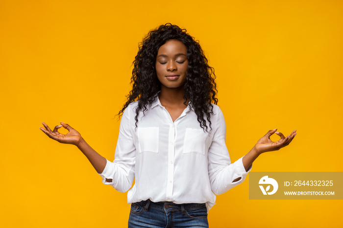 Young beautiful black girl practicing breathing yoga