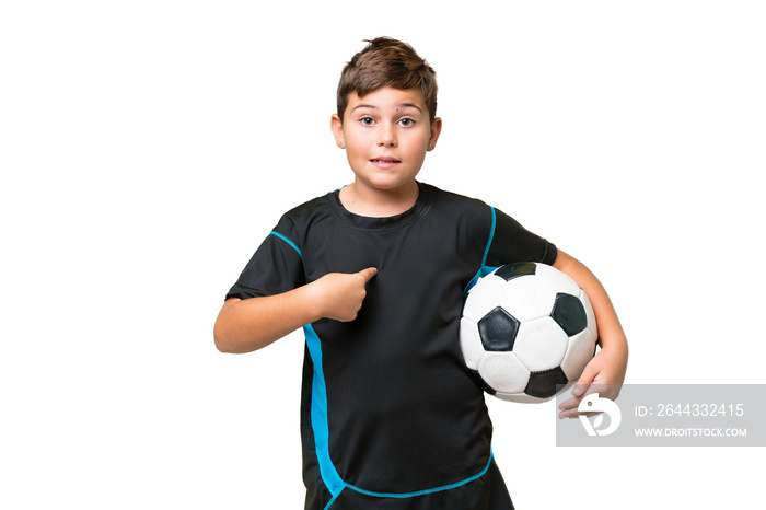 Little caucasian football player kid over isolated chroma key background with surprise facial expression