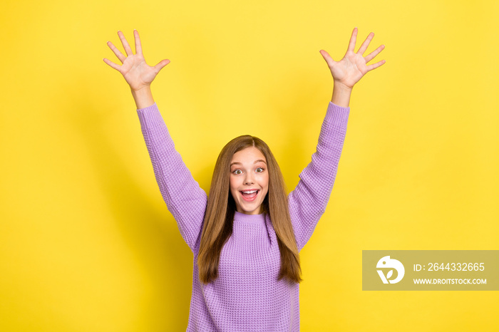 Photo of youngster teenager cheerful girl wear knitted violet sweater palms up good mood surprised excited isolated on bright yellow color background