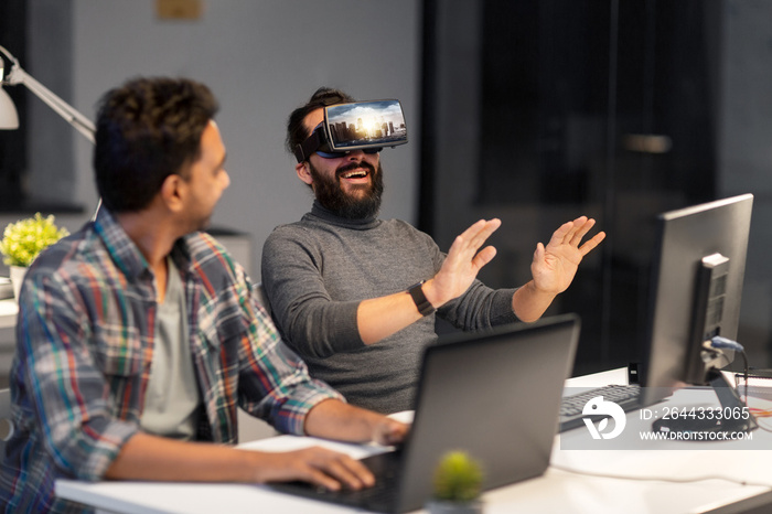 augmented reality and technology concept - developers with singapore city on virtual headset or 3d glasses screen working late at night office