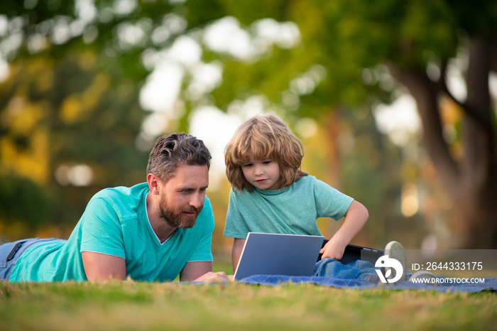 Father and son spending time outdoor together. Online learning.