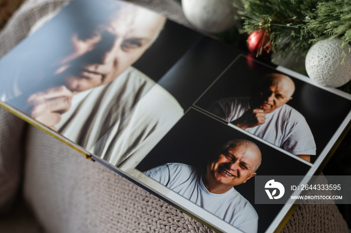 travel photo book near the Christmas tree.