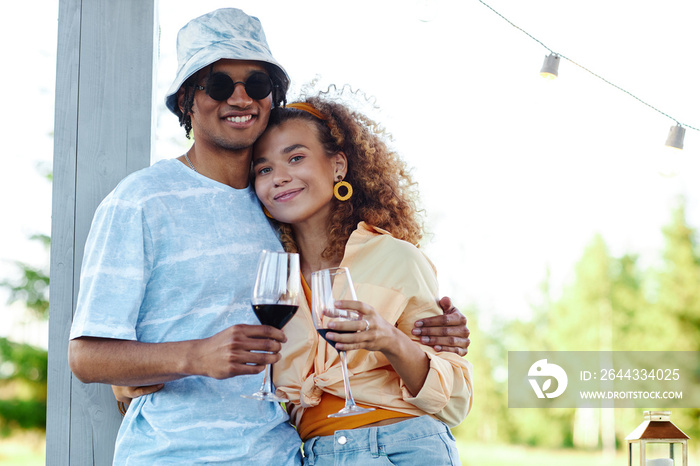 Waist up portrait of young couple embracing outdoors while enjoying romantic date in Summer , copy space