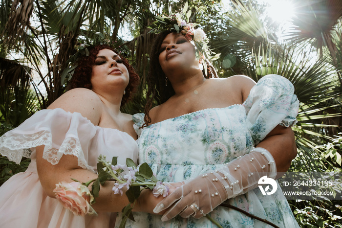 closeup of 2 plus size women standing and looking at the camera