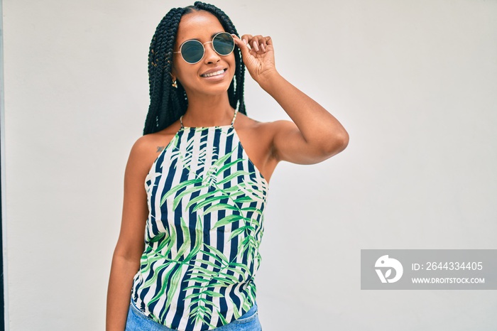 Young african american woman smiling happy walking at the city.