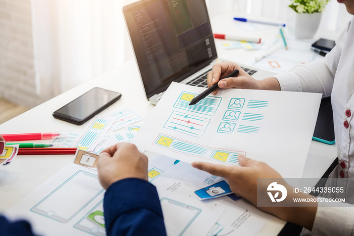 Programmer developing technologies about wireframe application designe of mobile phone. User experience Design concept.