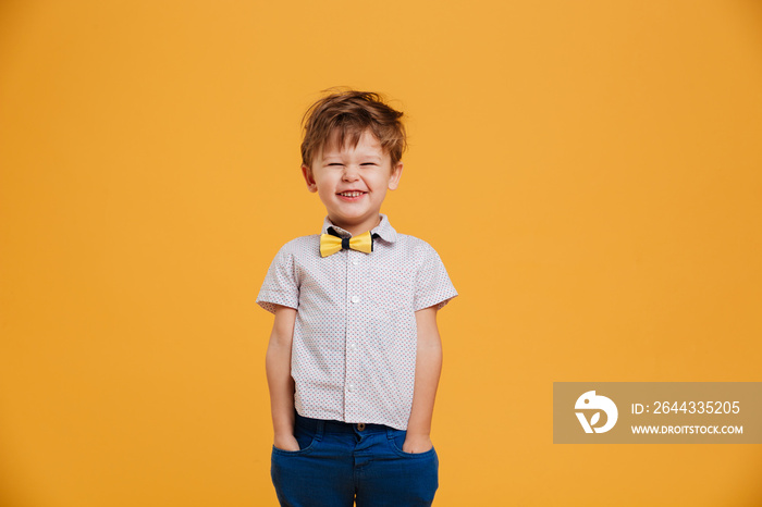 Cheerful little boy child standing isolated