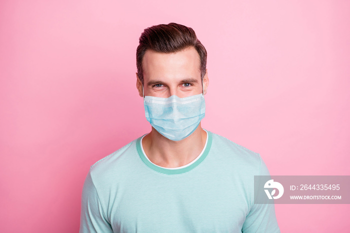 Close up photo of cheerful glad man look keep self-isolation social distance stop spread covid-19 infection wear white fabric mask isolated over pink color background