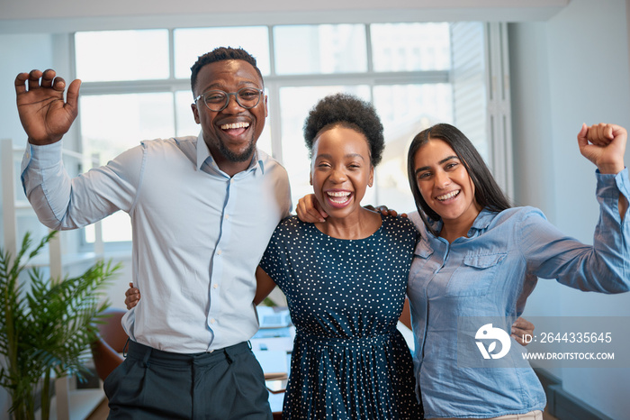 Three business people celebrate successful achievement in office cheer laugh