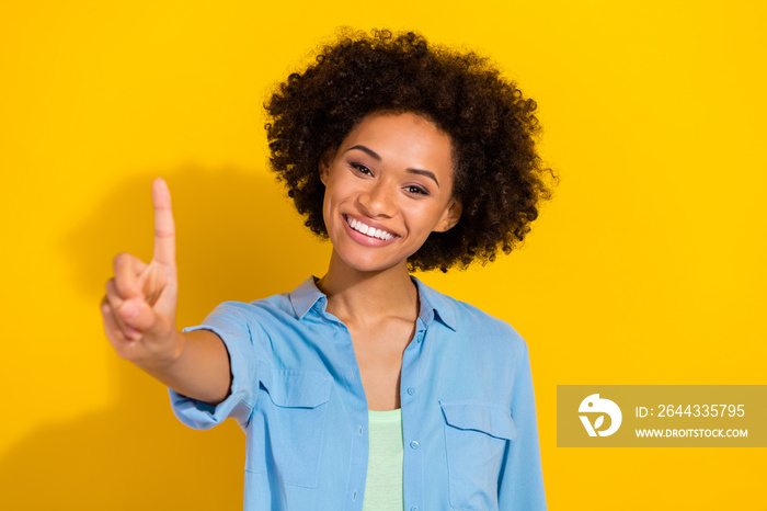 Photo of confident cheerful lady show one finger teaching concept wear denim shirt isolated yellow color background