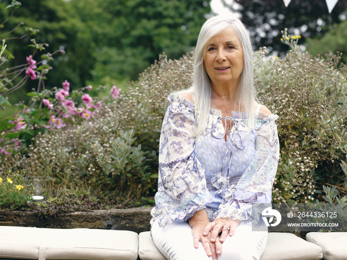 Portrait of senior woman sitting in garden