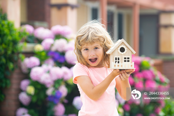 Excited child making a new dream home. Housing a young family. Amazed boy dream new home.