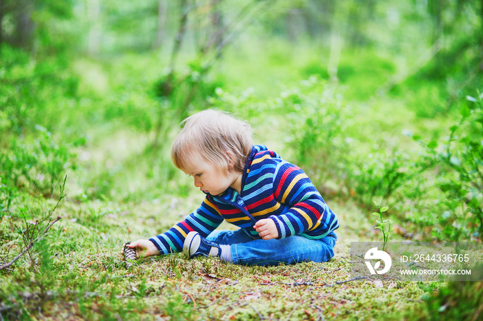 Adorable baby girl in the forest