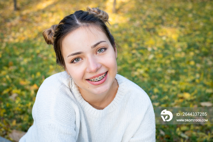 teenage girl with braces smiling