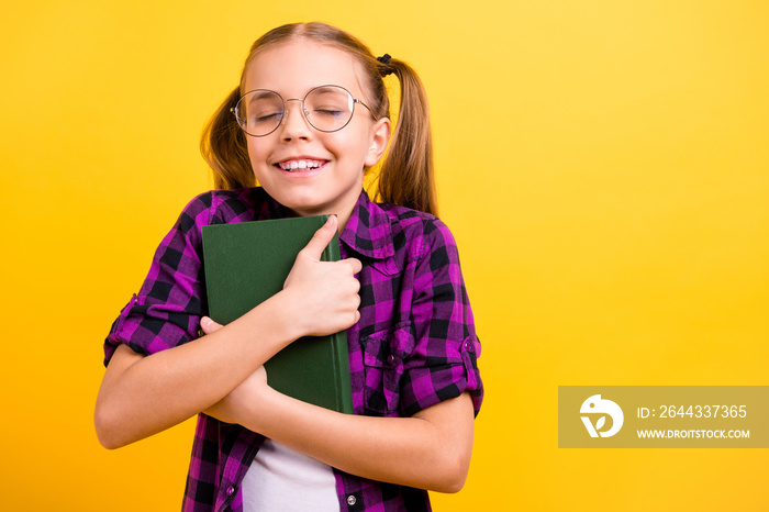 Photo of small lady pupil hold book close to chest eyes closed enjoy final wear specs checkered shirt isolated yellow background