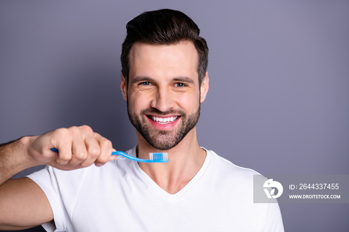 Close up photo amazing he him his macho cleaning mouth buy buyer new hand novelty plastic personal equipment tooth brush shower prepare working day wear casual white t-shirt isolated grey background