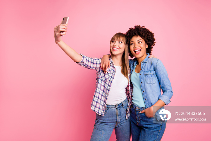 Portrait of two person nice cute lovely friendly attractive charming cheerful girls wearing casual checkered shirt making taking selfie day isolated over pink pastel background