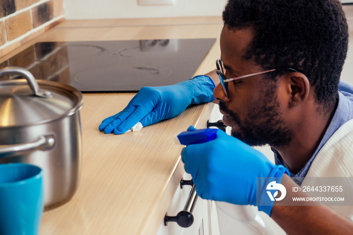 african man cleaning cooktop cooker hood at home ,Brick wall background