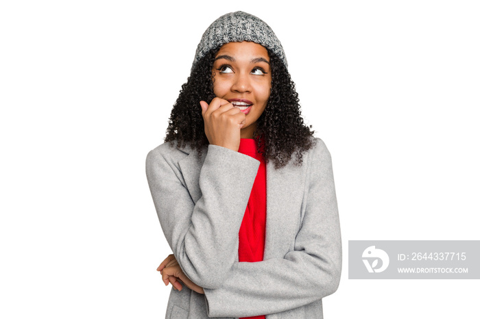 Young african american woman wearing winter jacket isolated relaxed thinking about something looking at a copy space.