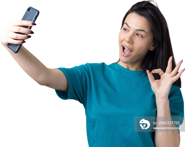 Portrait of a pretty girl taking a selfie isolated over grey background