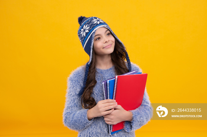 Autumn school holiday. Back to school. Teenager schoolgirl in autumn clothes on yellow isolated studio background. Happy face, positive and smiling emotions of teenager schoolgirl.