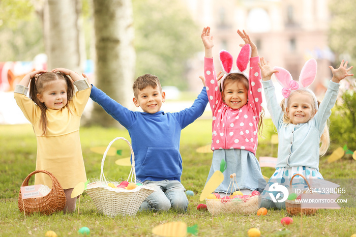 Children having fun in park. Easter egg hunt concept