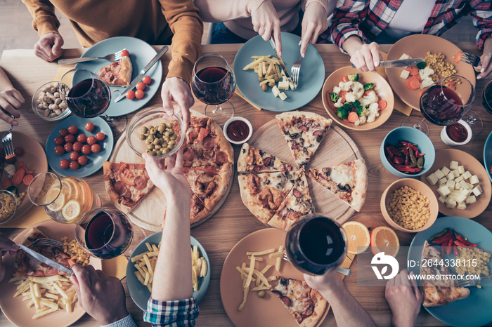 Cropped close up top above high angle view photo festive company social crowd event birthday members share eating beverage sit table full meals shirts formal-wear sweater pullover loft room indoors