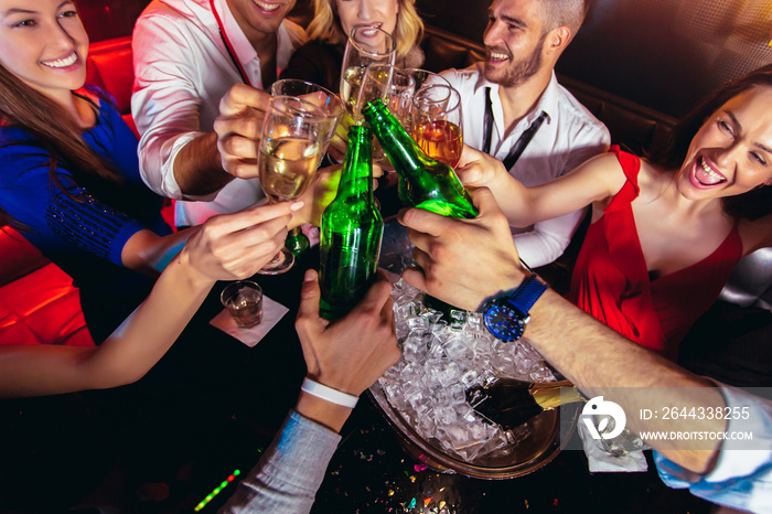 Happy young people having fun at nightclub.