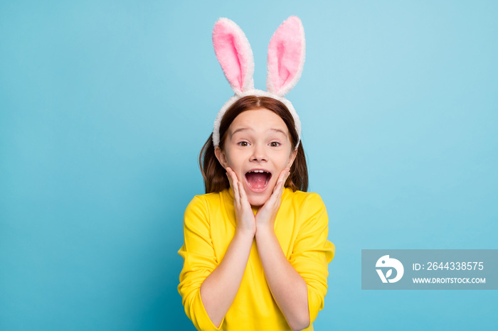 Close-up portrait of her she nice attractive lovely cute funny amazed cheerful cheery girl wearing rabbit ears having fun news reaction isolated over bright vivid shine vibrant blue color background