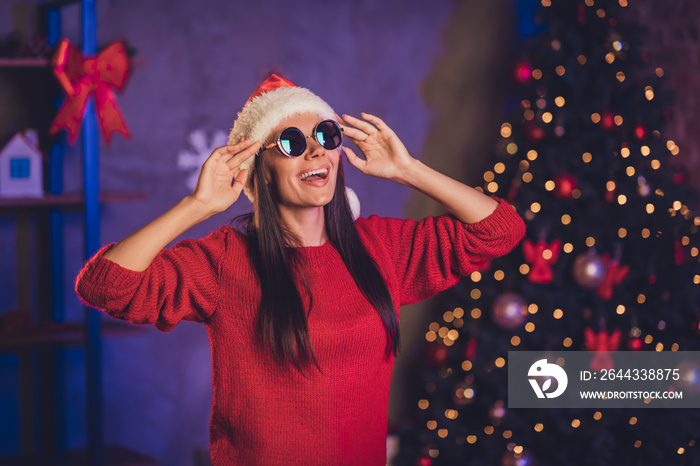 Photo of young happy smiling beautiful attractive joyful woman wear sunglasses santa claus hat celebrate new year at home house