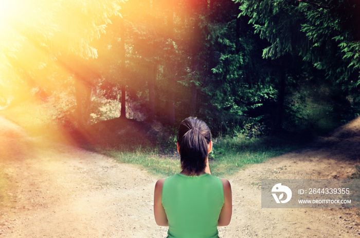 Girl with a choice near the forked road.The concept of the solution: the path to success and the path of risk